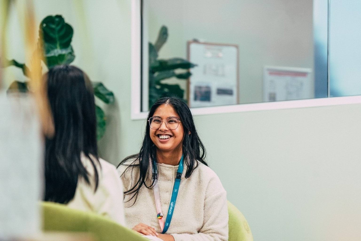A patient and a health professional sit talking 