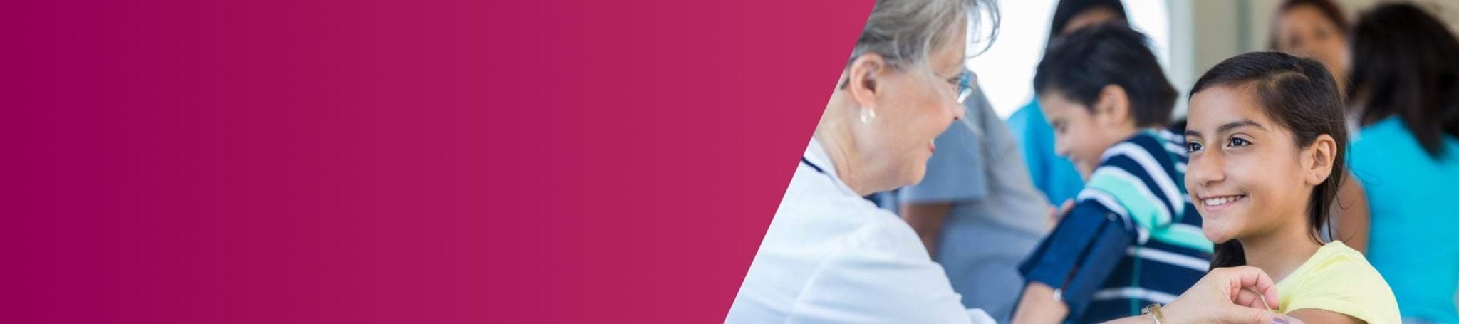 female health care worker talking to a child